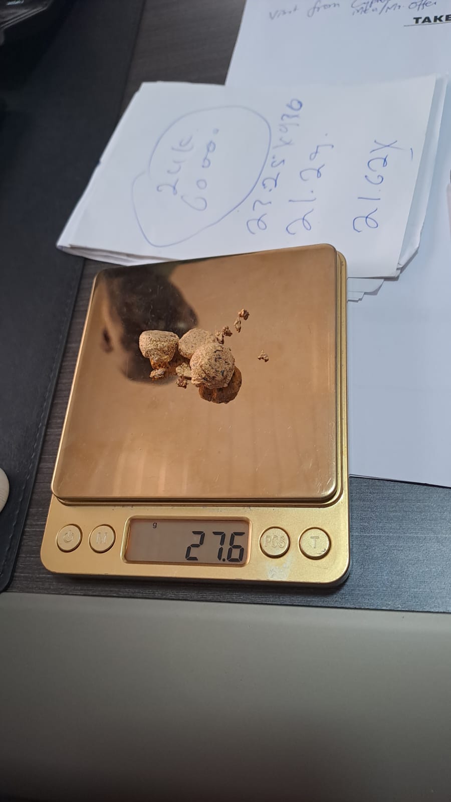 Gold nuggets on precision scale — 27.6g